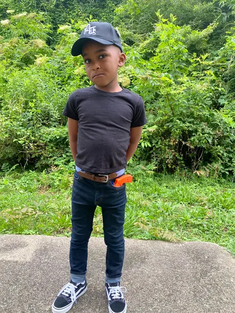 Child wearing the Daily Denim & Co. black embroidered cap outdoors